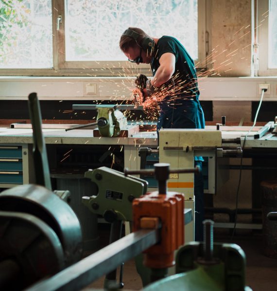 Man in workshop cutting metal making noise survey